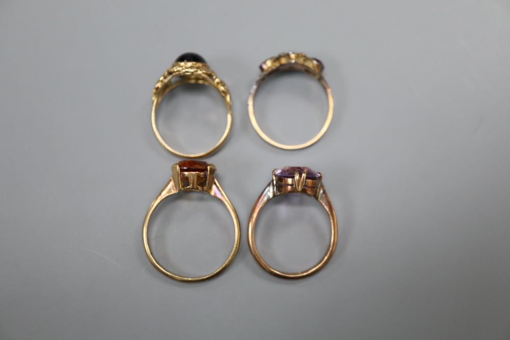 Four assorted early 20th century and later 9ct and gem set dress rings, gross 11.7 grams.